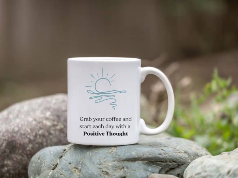 A coffee mug with the words "grab your coffee and start each day with a positive thought"